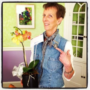 Oh, this is my mom. She is holding the orchid i got her for mother's day and wearing a pin with a baby pic of me. Precious.